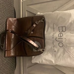 Brown croc print. Open zips from the top right corner down to the left bottom